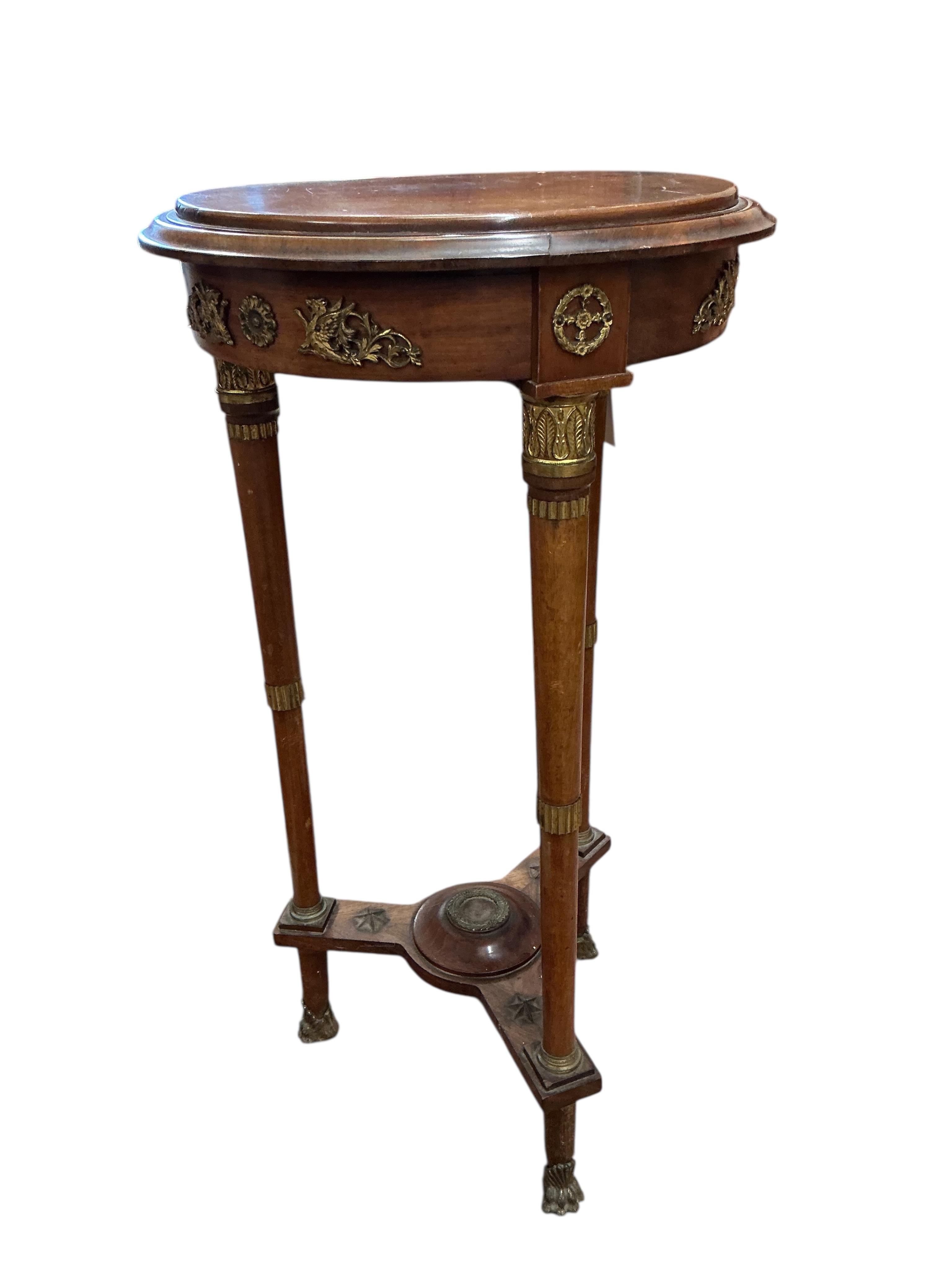 An empire style gilt metal mounted mahogany gueridon table